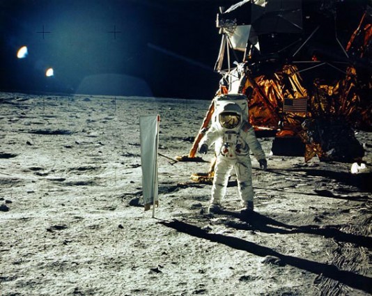 Buzz Aldrin stands on the Moon's surface