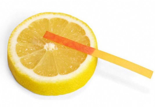 Litmus paper turns red on lemon, which is acidic.