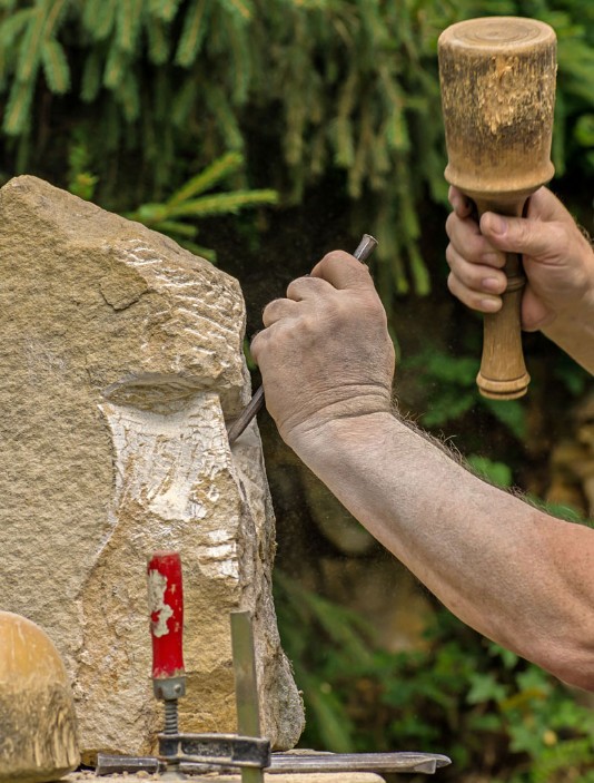 A figure starts to emerge from this block of stone