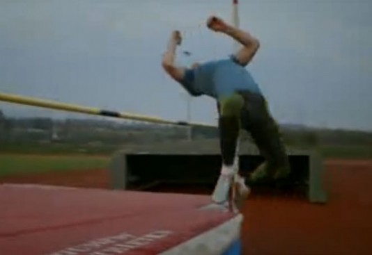 A high jumper successfully clears the bar.