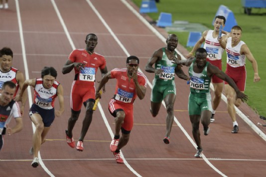 Runners passing on the baton in a relay race