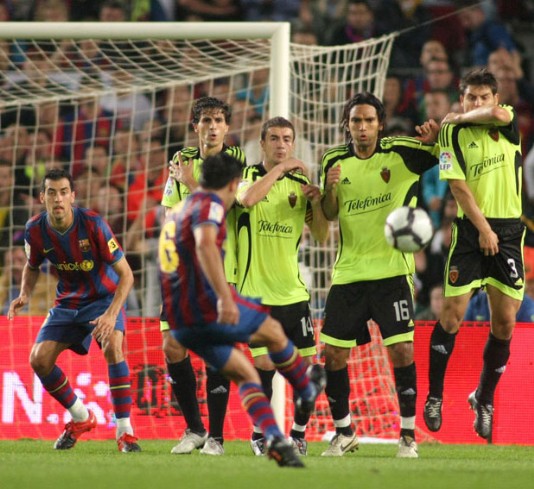 A player takes a free kick 