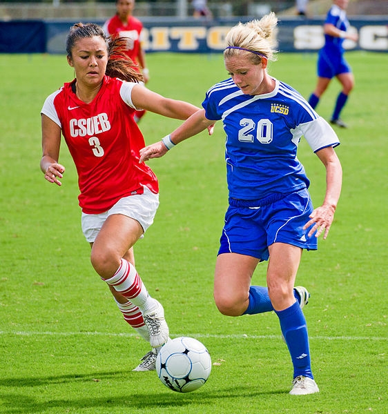 A player challenges another for the ball.