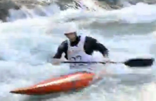 A competitor tackles a gate in a canoe slalom race.
