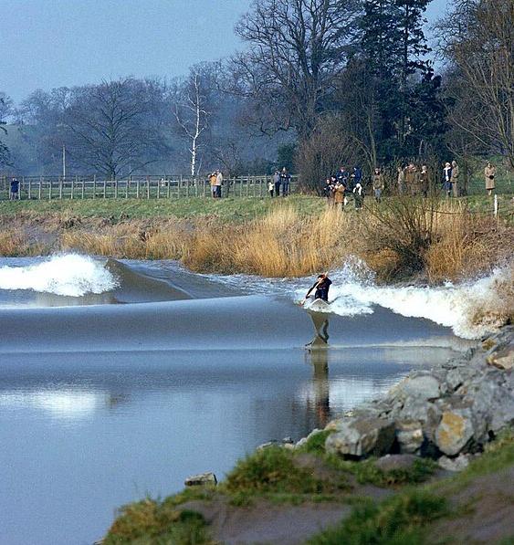 A surfer rides the Severn bore