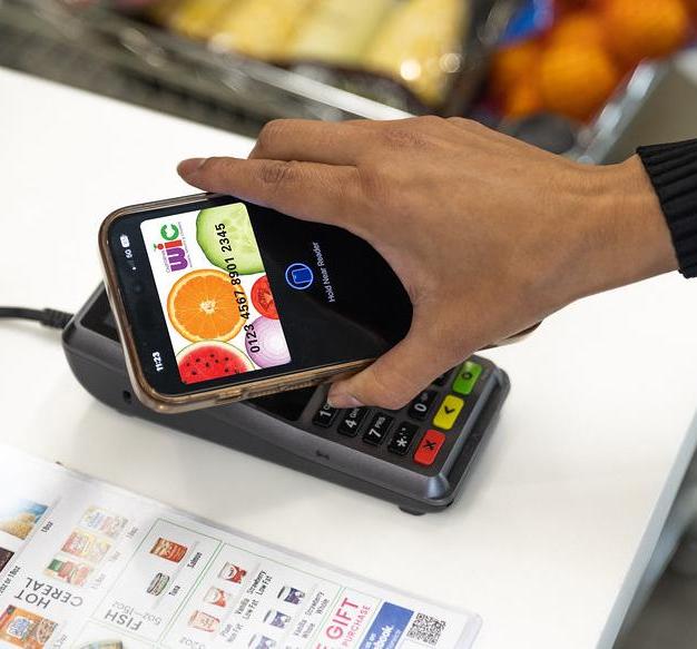A customer makes a payment using their smartphone
