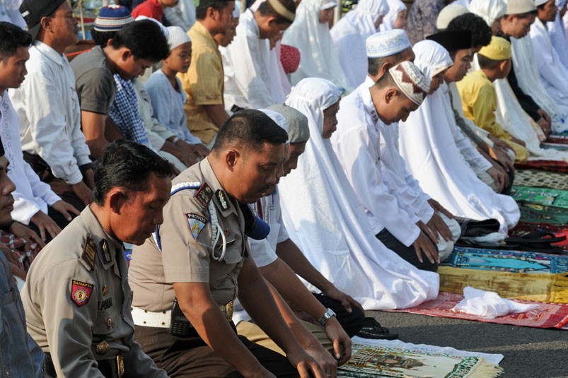 Muslims, including police officers, praying