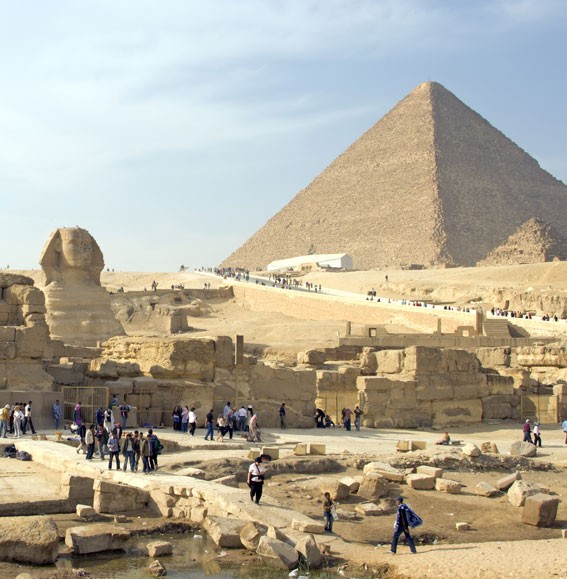 Tourists visit the pyramids and Sphinx at Giza