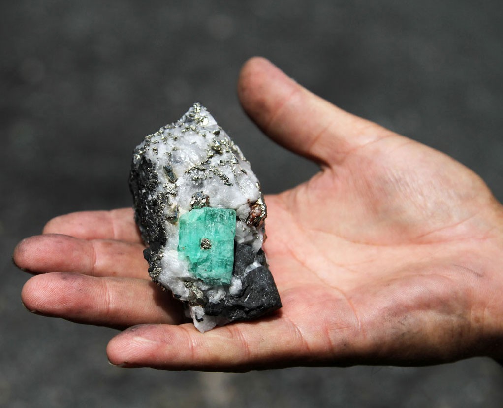 A miner holds an emerald