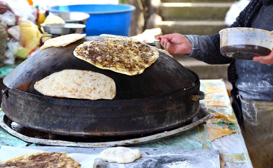 Making zaatar bread on a convex oven
