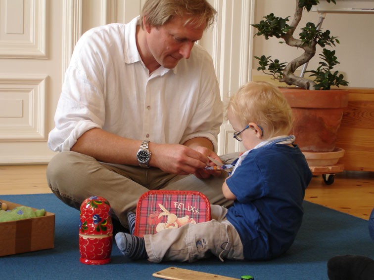 A psychotherapist works with a young patient