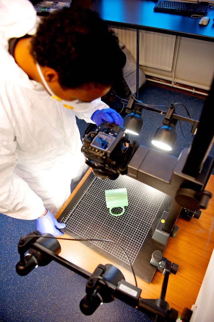 Forensic investigator photographing evidence