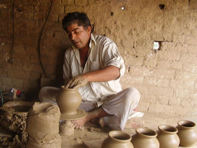 A potter working clay, a plastic material