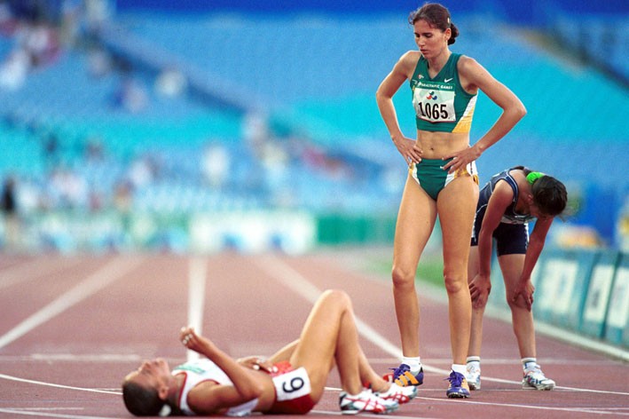 An athlete collapses with exhaustion