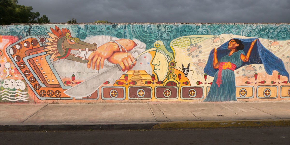 A mural showing Quetzalcoatl and a dancer