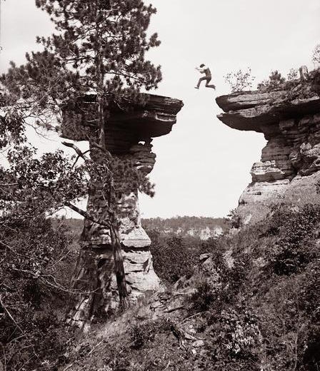 A boy jumps on to Stand Rock, Wisconsin Dells, 1886.