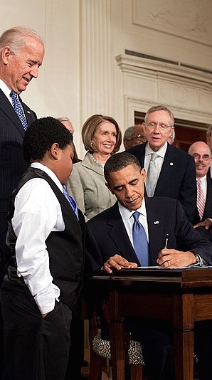 Barack Obama signs the Obamacare Act