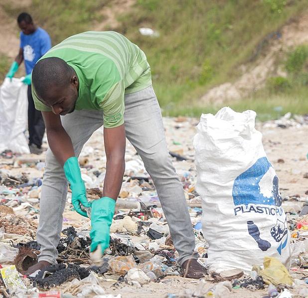 Collecting plastic waste from a beach in Ghana