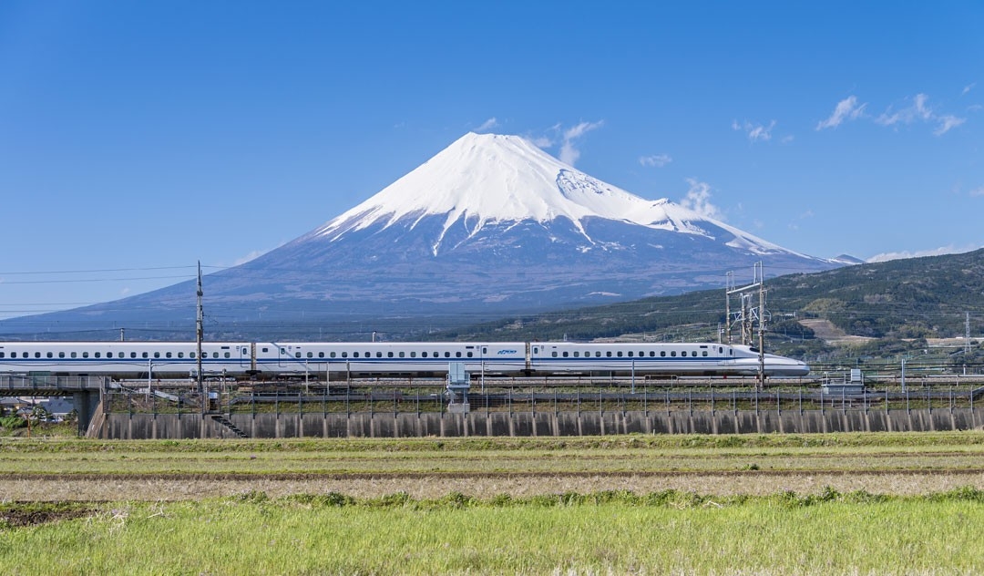 A "bullet train" speeds past Mount Fuji.