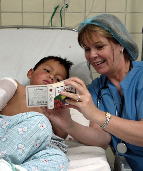 A nurse caring for a sick child in hospital