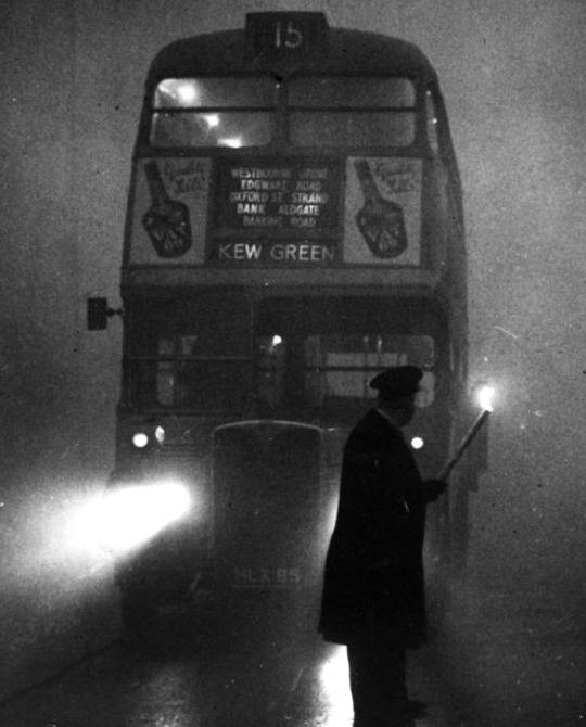 A London bus drives through the Great Smog, 1952