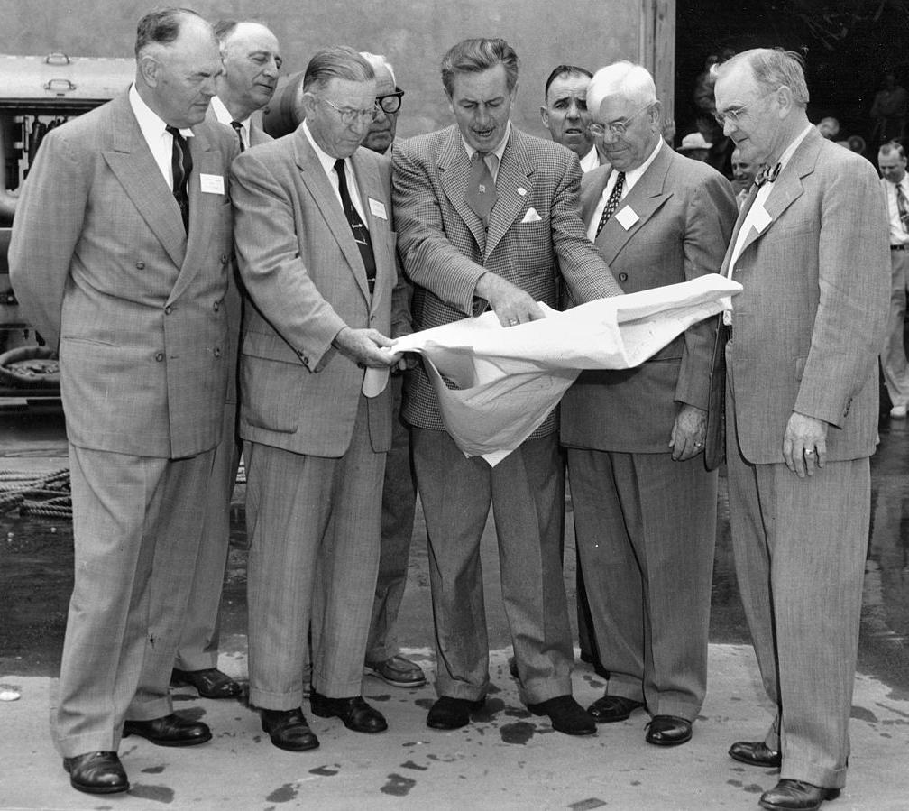 Walt Disney (centre) with his plans for Disneyland in 1954