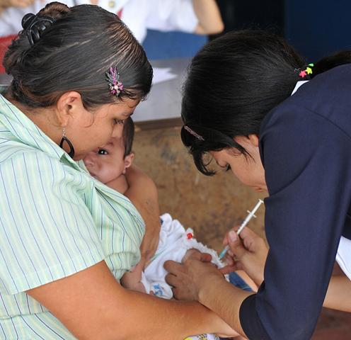 A nurse vaccinates a baby with the MMR vaccine