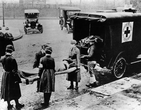 Red Cross volunteers carry a victim of the Spanish flu