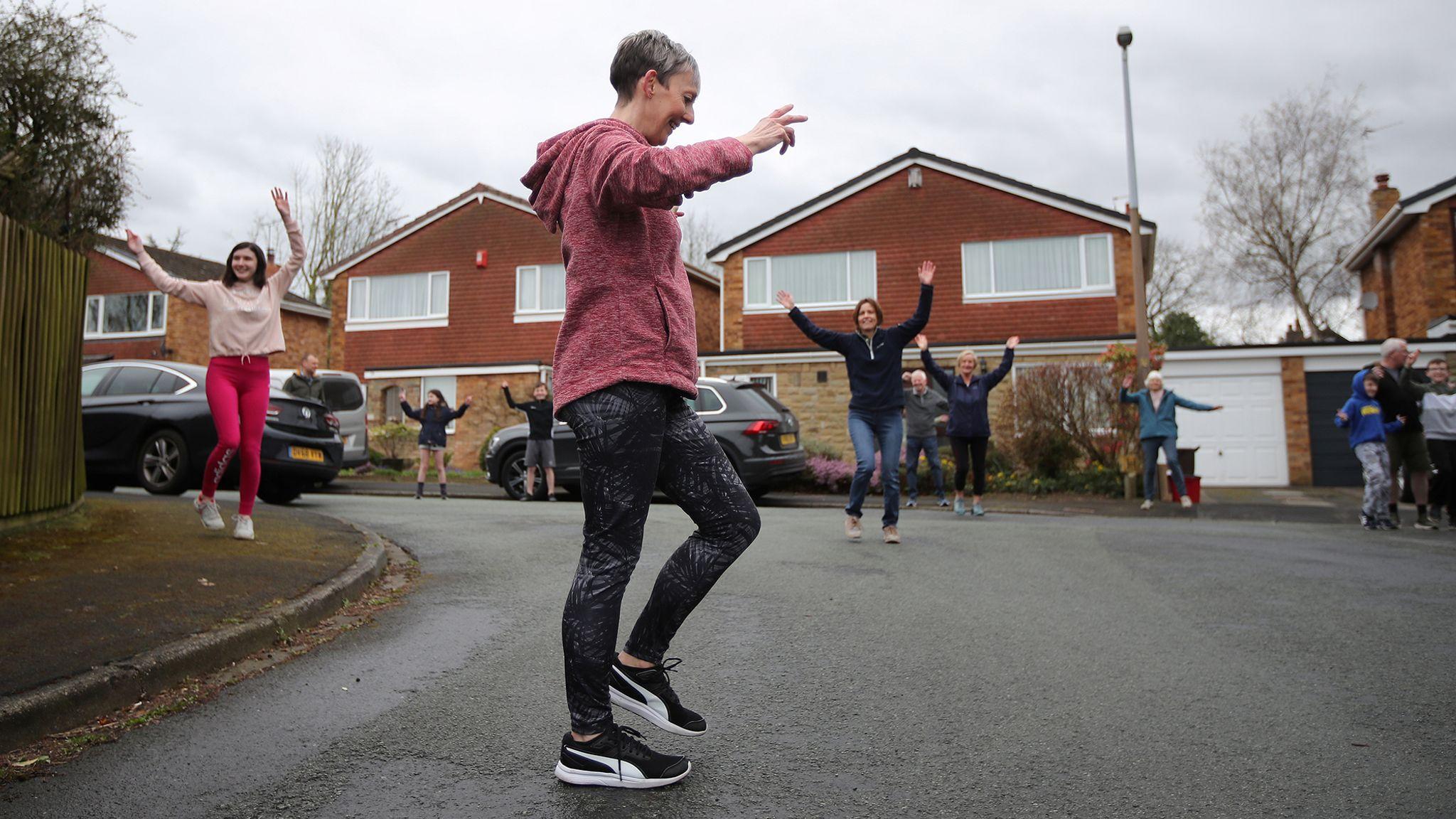 Neighbours join a dancing session during lockdown in the UK, April 2020.