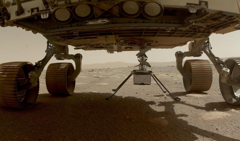 Perseverance lowers Ingenuity on to the surface of Mars.