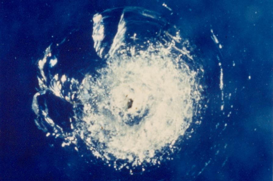 Impact crater in Space Shuttle window created by a paint flake