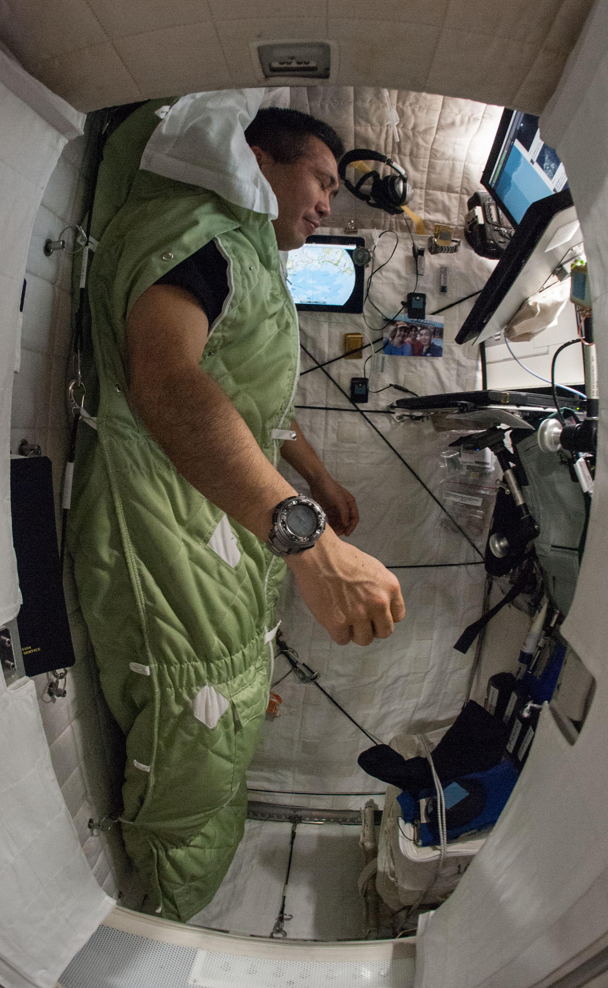 Crew member strapped into his sleeping bag
