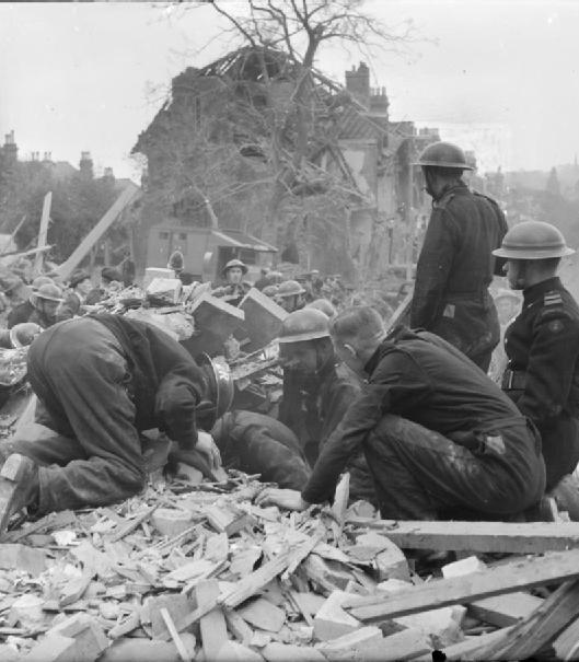 Rescue teams search through the rubble after a V-1 attack