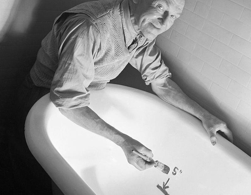 Hot water rationing: marking a five-inch limit in a bathtub