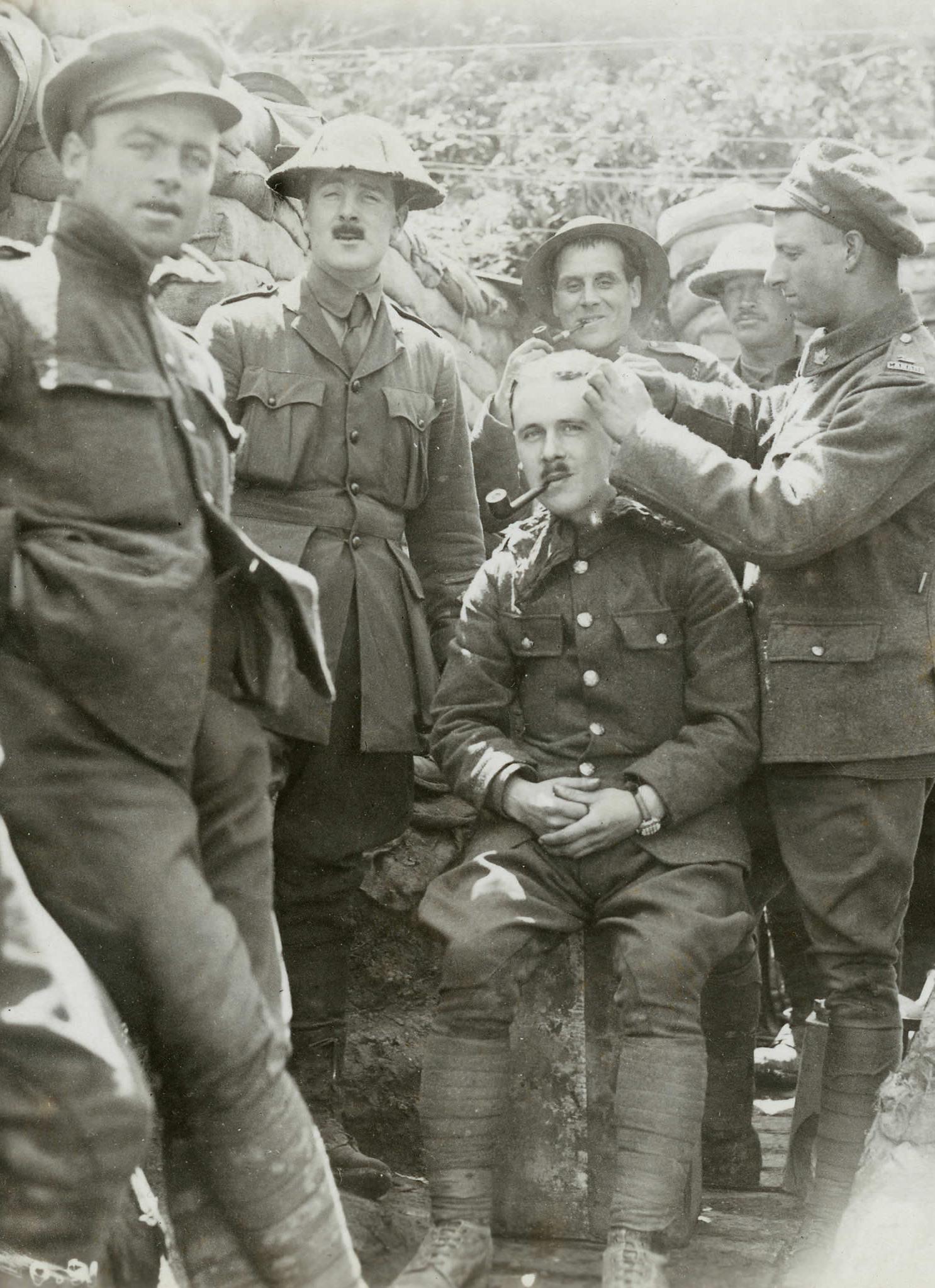 A Canadian soldier gets a haircut in the trenches