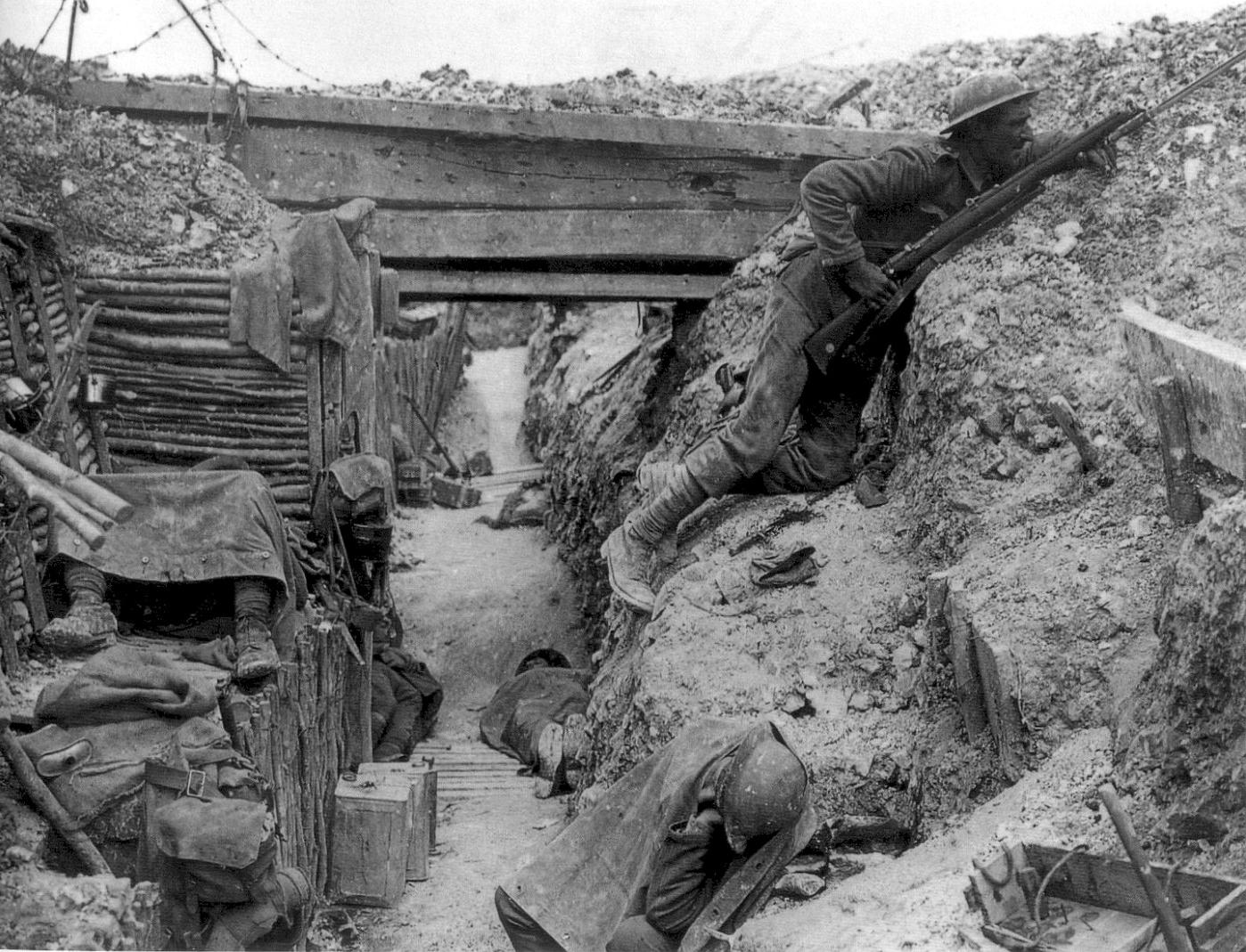 A sentry keeps watch while the other soldiers sleep
