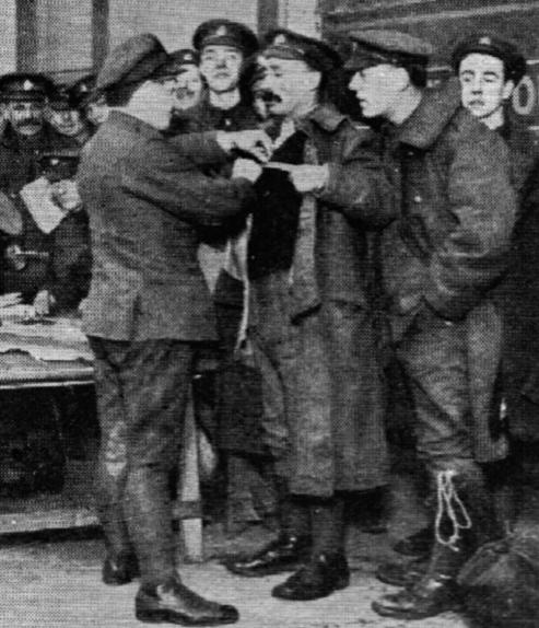 Men passed for demobilization are measured for civilian clothes.
