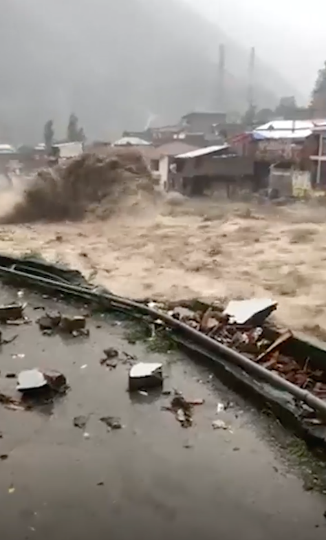 A torrent hurtles through a town in northern Pakistan, August 2022