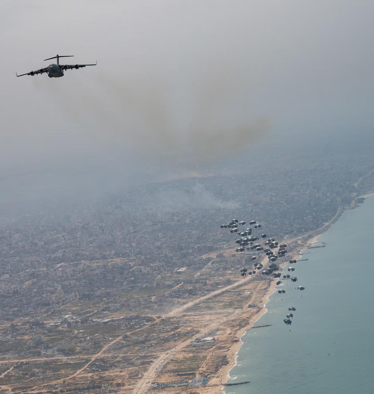 A US Air Force plane drops aid by parachute into Gaza