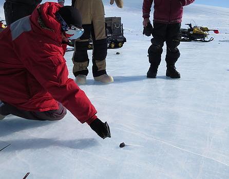 Researchers examine a meteorite