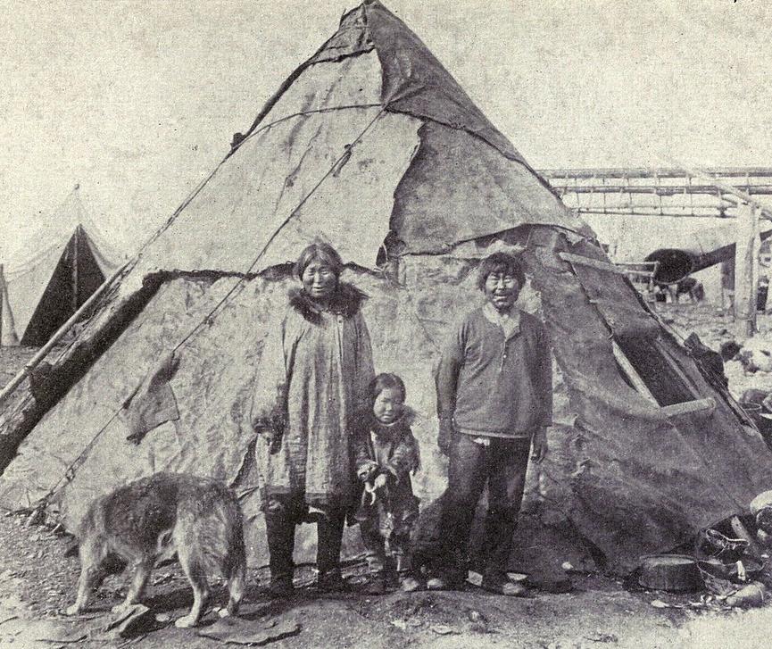 Inuit family outside their tupik, a traditional tent (1915)