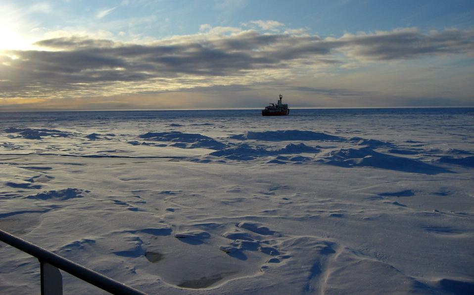 Canadian Arctic sea ice, with an icebreaker seen in the distance