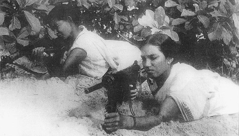 Two rebel women fighters with guns, photographed in 1948 during the Telangana Rebellion