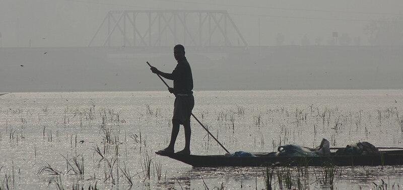 Fisherman at Deepor Beel on a foggy winter afternoon
