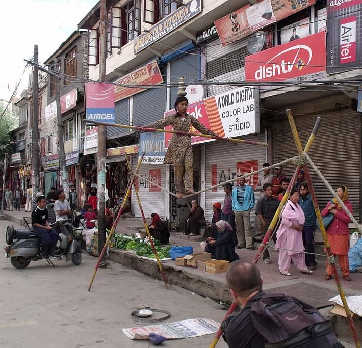 An acrobat performs on the streets of Leh