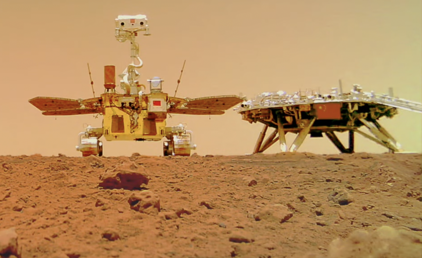 Zhurong rover (left) with lander (right), taken by the Tianwen-1 Remote Camera from the surface of Mars.