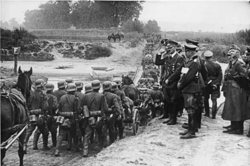Hitler watches on as German soldiers march into Poland in September 1939