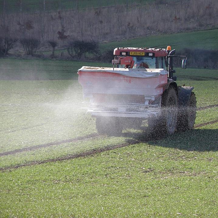 Ammonium nitrate fertilizer being applied to a crop