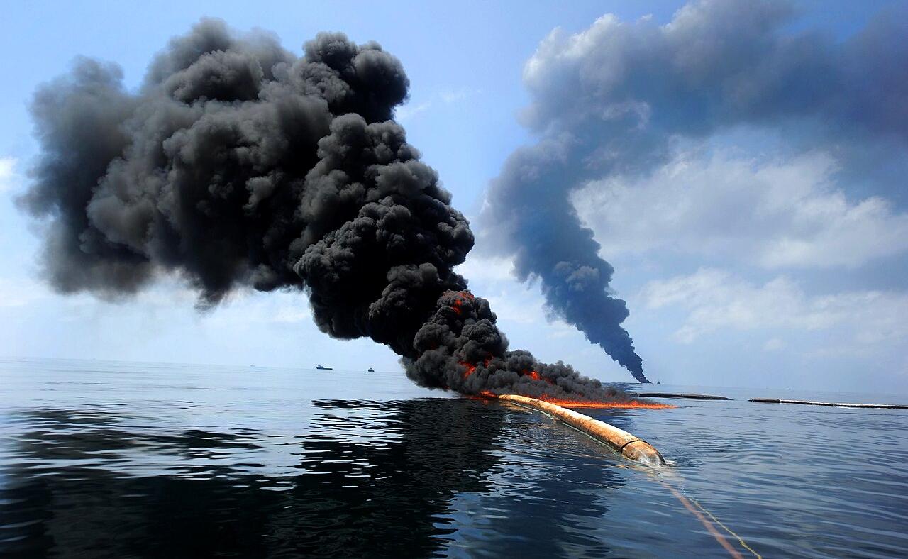 Dark clouds of smoke emerge as oil burns during a controlled fire in the Gulf of Mexico, 6th May 2010, following the Deepwater Horizon disaster.