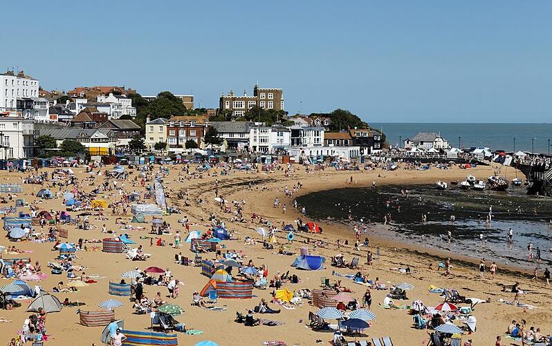 Holidaymakers enjoy the summer sunshine on a beach